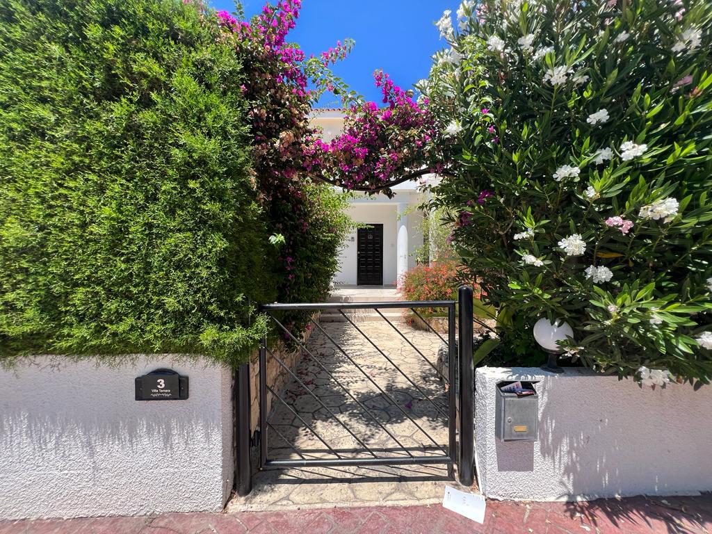 Gated entrance with the Villa Tamara nameplate beside steps up to the garden