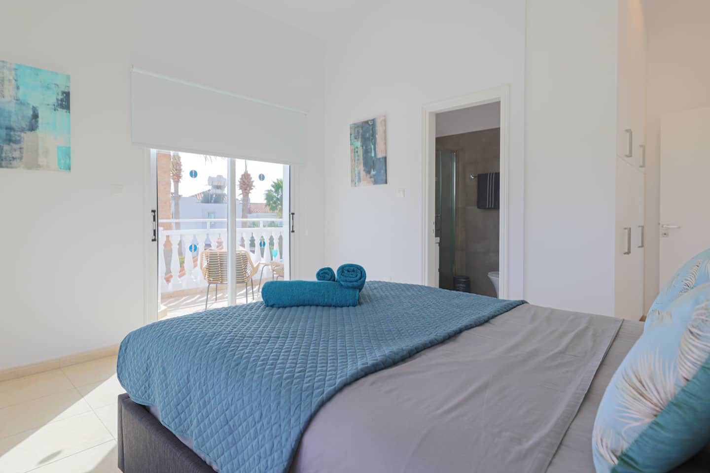 Double bedroom with balcony doors onto palm trees and its own en-suite shower room